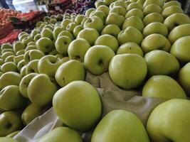 Group of green apples in market photo