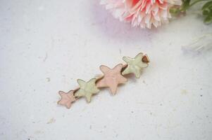 Colorful hair clips on a white background, with a flower. Top view. photo