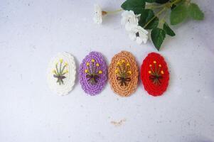 Colorful hair clips on a white background, with a flower. Top view. photo