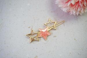 Colorful hair clips on a white background, with a flower. Top view. photo