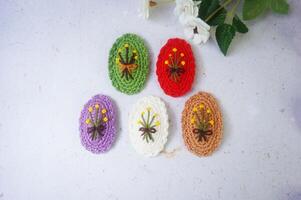 Colorful hair clips on a white background, with a flower. Top view. photo