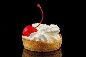 Baskets of pastries with cherry and cream. Close-up of a shortbread basket with cream and cherries photo