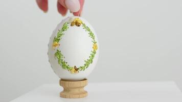 Easter spring holiday cooking krashenok decorate egg shells embroidery on goose eggs female hand puts finished products white manicure light background handmade expensive thing easter eggs video