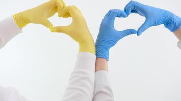 Hands forming a heart in colors of national flag of Ukraine. Isolated on white background with clipping path. peace love friendship no war help medical care doctors make heart with hands on video