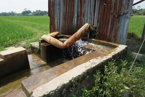 a water pump is running in a field photo