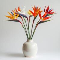 Contemporary ceramic vase shows a group of birds of paradise in bloom. photo