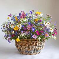 Rustic wicker basket filled with colorful wildflowers. photo