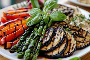 Grilled vegetables include asparagus, eggplant, and bell peppers, topped with a balsamic glaze. photo