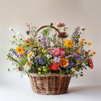 Rustic wicker basket filled with colorful wildflowers. photo