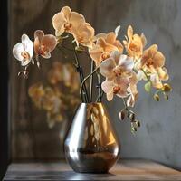 A sleek metal vase displays a group of elegant orchids. photo