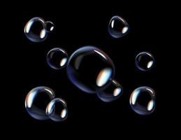 Glossy soap bubbles on black background. Transparent soap bubbles with reflection. photo