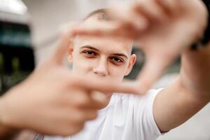 A man with a shaved head is holding his hands together in a frame photo