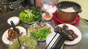 Vietnamese food shells mussels fish cooking Vietnamese soup with green leaves and pieces of meat video