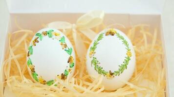 ribbon embroidery on eggshells ribbon embroidery technique eggshells for Easter holiday originated in Germany two eggs with green brown ribbons on spikelets of wheat and shavings for packaging video