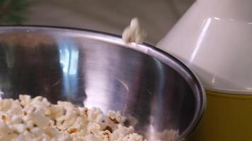 cooking popcorn at home in a special machine caramel filling caramelized popcorn recipe close-up delicious treat for movie stir and pour caramel icing popcorn grains iron utensil appetizing snack video