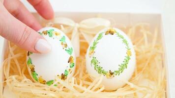 ribbon embroidery on eggshells ribbon embroidery technique eggshells for Easter holiday originated in Germany two eggs with green brown ribbons on spikelets of wheat and shavings for packaging video