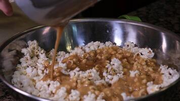 caramel drizzle over popcorn in a rustic bowl video