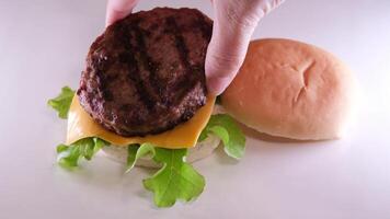 plier une Burger créer une Burger couverture avec une chignon mettre oignon escalope tomate verser moutarde ketchup mettre fromage et salade propager Mayonnaise sur le chignon le entier processus dans différent s video