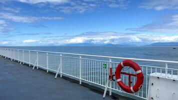 the deck of the ship is visible Only the white bridge and the red rescue circle as well as the sky The Pacific Ocean restless water on the sea Calm relax travel travel agency that will always save video