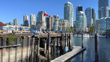 Granville Island peninsula and shopping district in Fairview district of Vancouver BC across False Creek from downtown Vancouver under southern end of the Granville Street Bridge Canada video