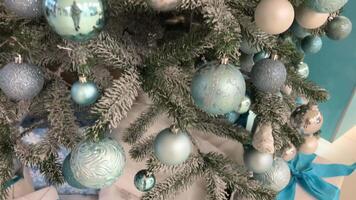 Christmas background New Year Green Christmas tree with white snow on it blue and silver balls Nice pastel light color video