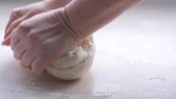 vrouw handen maken pizza deeg vrouw handen kneden deeg voor bakken brood. vroeg ochtend- bakkerij detailopname visie van vrouw handen kneden deeg in meel bakker bereidt zich voor de deeg video