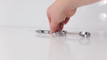 A woman holds a medical injection syringe on the outstretched side of her arm towards the camera. Selective focus, advertising space video