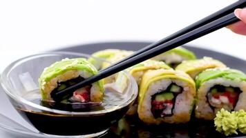 Space for text Sushiya restaurant serving delicious food japanese chinese Asia Japan delicious food healthy Sushi rolls green dragon eel avocado sesame unagi cucumber and red tobiko caviar video