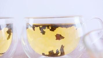 glass cup with a double bottom black tea is brewed immediately in a large-leaf glass swirling in hot water video