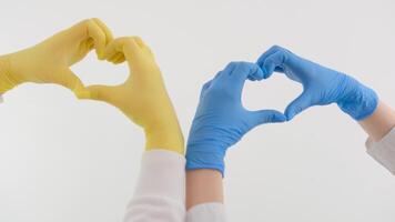 The Ukrainian flag is drawn on hands. Selective focus.gloves blue yellow heart with hands on white background space for text video