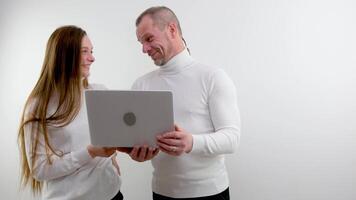 sincere smile laughter joy love man and woman with laptop in hands having fun something funny joke successful project good shopping end of work office holiday advertising space for text real people video