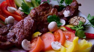 Slices of beef steak with grilled vegetables on cutting board on wooden table, top view Grilled tuna steak in sesame breading with vegetables video