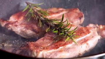 Fry meat beef with thyme and Rosemary Barbecue Aged Roast Beef cooking on pan Raw sausage and rosemary in foil video