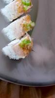 delicious restaurant asian food sushi on plate with dry ice eel tuna set enveloping all around space for text advertising sushi serving menu chef courses sushi maker close-up incredibly delicious video