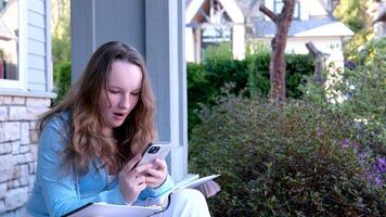 gorgeus blonde woman typing on smarphone outdoor video