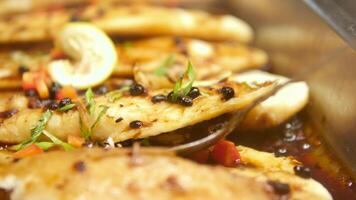 A soy-based brown sauce is poured over a spiced raw fish. basa fillet black bean souse video