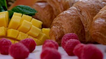 croissant, fruit salad on the beach vacation, relax, travel concept video