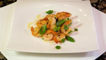 Roasted Prawns on frying pan served on white wooden cutting board video