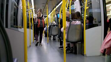 Sky travel in city of Vancouver Canada 09.09.2023 people enter half-empty train carriage Travelers with backpacks Canadian residents of different nationalities unrecognizable people no faces visible video