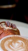 Cinemagraph - top view of served breakfast. Appetizing crunchy croissants with hot coffee, raspberries and walnuts video