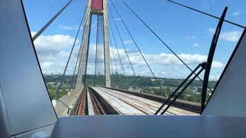 Skybridge TransLink back window train on the bridge another blue train passes light traffic in big cities vancouver ordinary people work road comfort tourists canada vancouver video