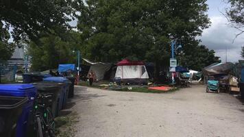 a place in downtown Vancouver where homeless people live in tents, trash cans, awnings are pulled up, there is no one around video