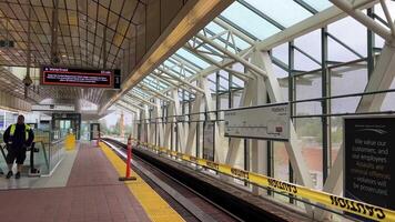 renovation of Sky Train station on Surray Central no entry exit Use same platform in both directions Be careful Do not cross the yellow line of inscription people waiting for train barrier 06.19.2023 video