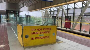 renovation of Sky Train station on Surray Central no entry exit Use same platform in both directions Be careful Do not cross the yellow line of inscription people waiting for train barrier 06.19.2023 video