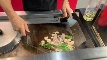 Stir-frying chinese vegetables in a wok video