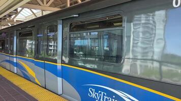 sky train old model departs King George station leaves by rail to Surrey Central station Canada Surrey video