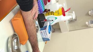 Close up of nurse disinfecting male arm before blood test. Man is sitting on chair near medical set Skillful general practitioner testing male blood video