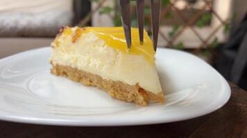 Footage of a fork scooping delectable sweet and tart lemon cream cheese pie video