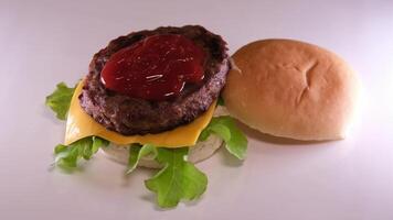 Fresh tasty burger isolated on black background video