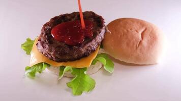 piegare un' hamburger creare un' hamburger copertina con un' ciambella mettere cipolla cotoletta pomodoro versare mostarda ketchup mettere formaggio e lattuga diffusione Maionese su il ciambella il totale processi nel diverso S video